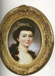 A bust portrait of a young woman with fair skin and dark brown hair.