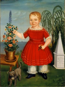 A portrait of a child in a red outfit holding flowers. A small cat is beside the child.